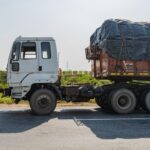 Side view of an Indian truck on a highway in Deeg, Uttar Pradesh, India during the day.